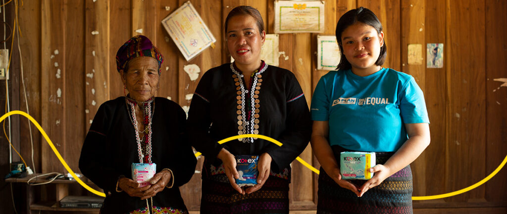 Multigenerational group of women holding feminine products in support of Menstrual Health Day